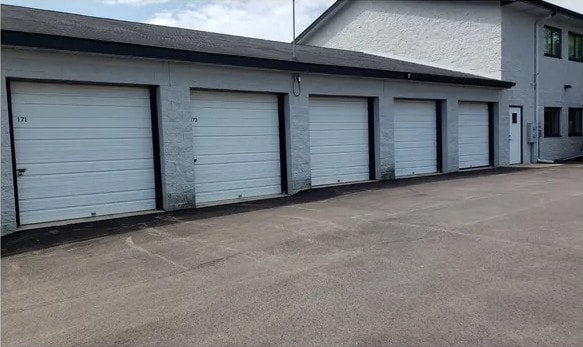 Hwy 50 Storage — exterior building showing numbered roll-up garage doors and wide drive aisle